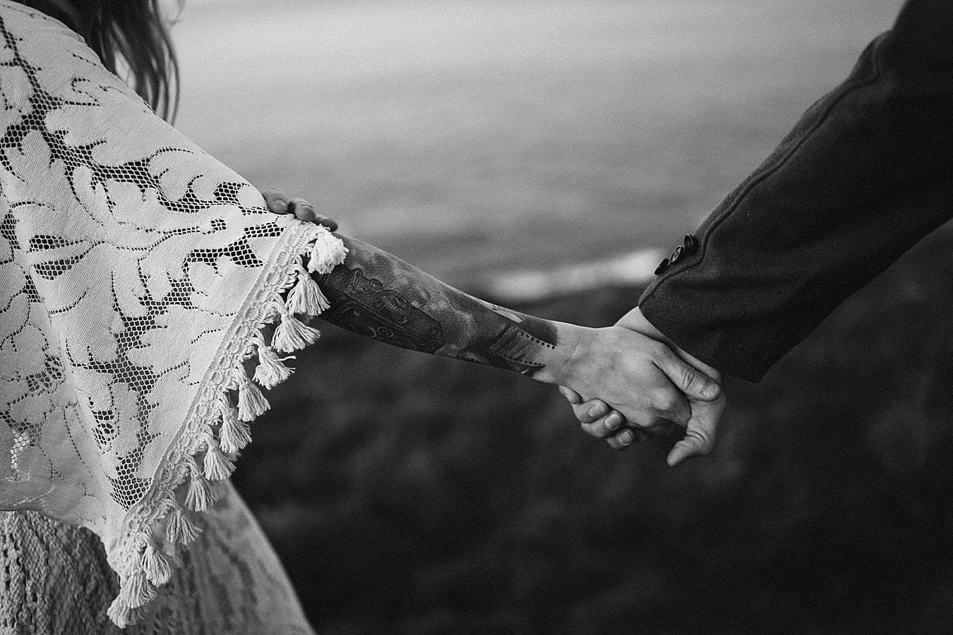 Black & white image of a couple holding hands. Adventure elopements in Northern Ireland. A romantic adventure session in Northern Ireland. Causeway Coast couples session. Ireland couples session. Ireland elopement photographer. 