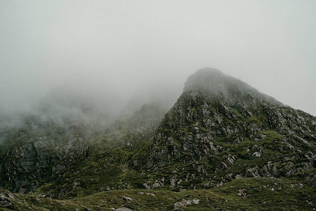 Mist rolling over the tops of the mountains at the Connor Pass in Co Kerry, Ireland.